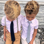 Two boys wearing navy and dusty blue kids ties