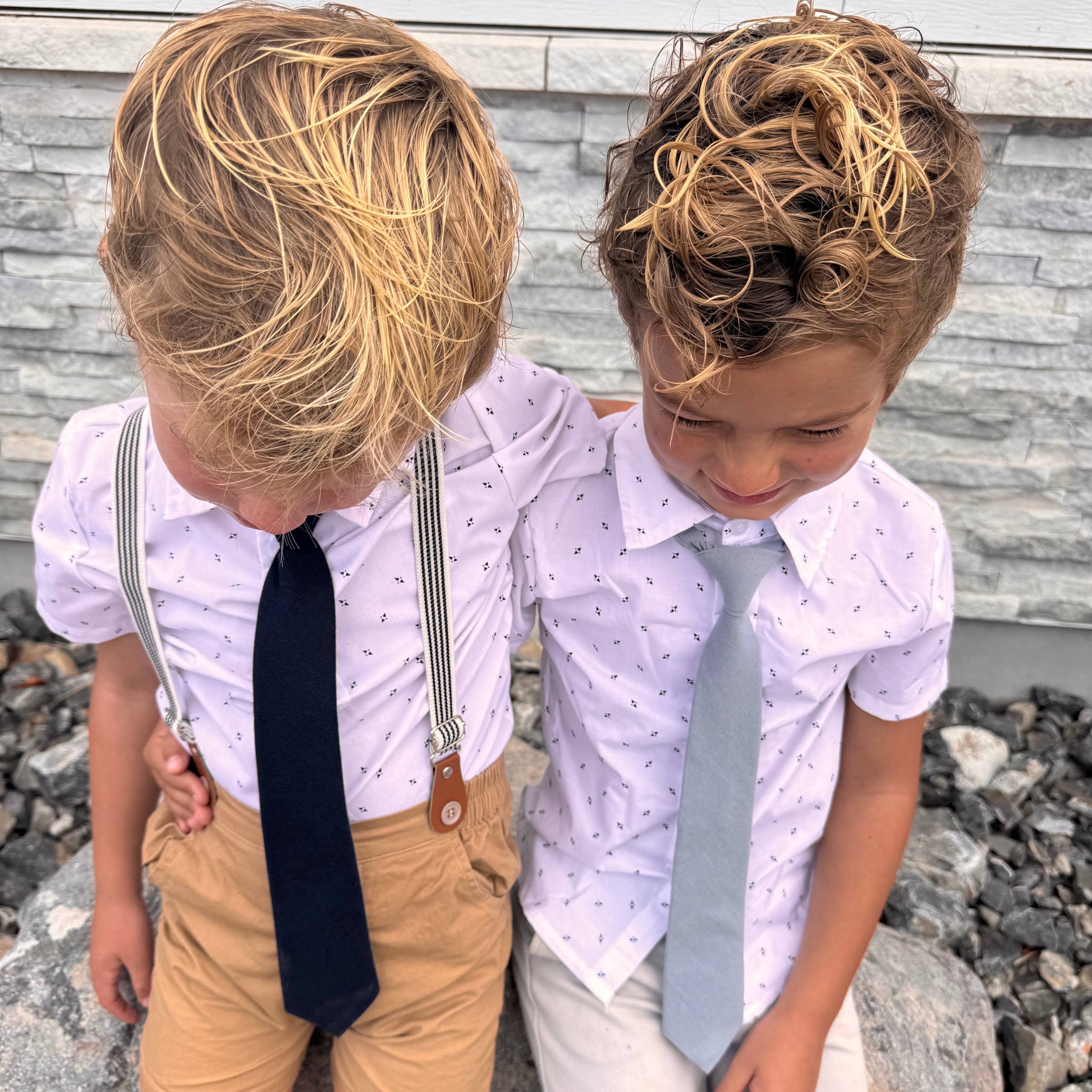 Two boys wearing navy and dusty blue kids ties