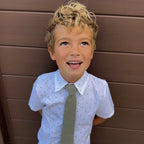 Boy wearing a sage green kids tie